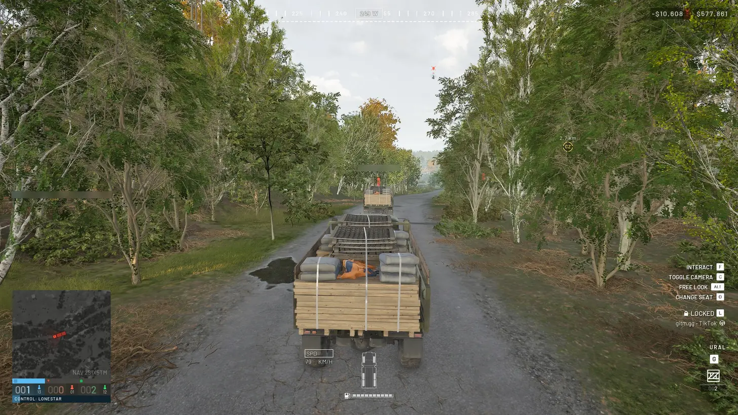 Driving a loaded Ural truck down a forest road behind another supply truck